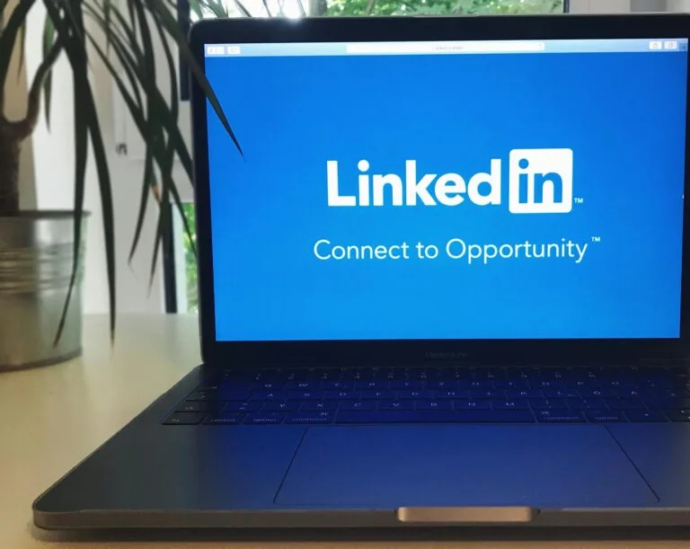 The Essentials of Blogging: Tips and Strategies for Success A laptop screen displaying the LinkedIn logo with the text 'Connect to Opportunity'.